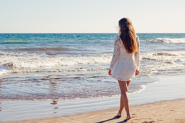 Woman with eczema walking on the beach
